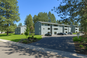 Spokane multi-family for rent - Apartment complex with a parking lot in front.