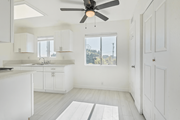 Sun Valley multi-family for rent - A white kitchen with a ceiling fan and a window.
