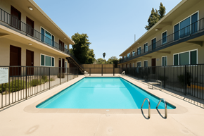 Azusa multi-family for rent - A swimming pool in front of a row of apartment buildings.