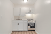 Pico Rivera multi-family for rent - A kitchen with white cabinets and a stainless steel oven.