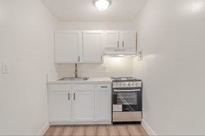 Pico Rivera multi-family for rent - A kitchen with white cabinets and a stainless steel oven.