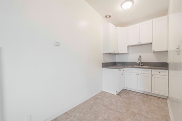 Downey multi-family for rent - A kitchen with white cabinets and a sink.