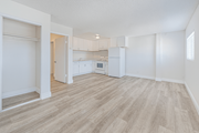 Wilmington multi-family for rent - A kitchen area with a refrigerator, sink, and cabinets.