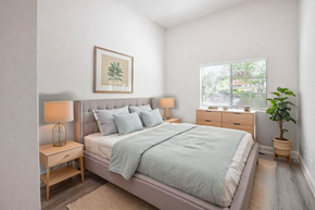 El Monte multi-family for rent - A bedroom with a bed, nightstands, and a plant.
