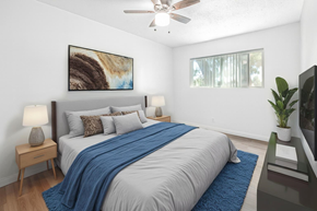 Azusa multi-family for rent - A bedroom with a large bed and a painting on the wall.