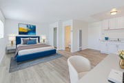 Wilmington multi-family for rent - A bedroom with a blue bedspread and a painting on the wall.