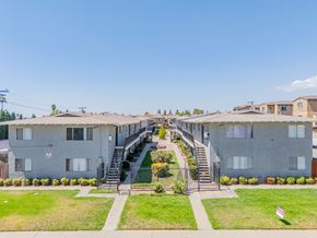 Rialto multi-family for rent - Apartment complex with a staircase leading to the entrance.