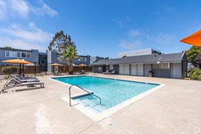 Lompoc multi-family for rent - A swimming pool surrounded by a concrete patio and a metal fence.