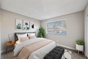 Moreno Valley apartment for rent - A bedroom with a large bed and a plant on the windowsill.
