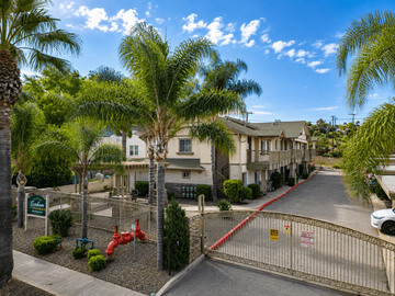Lake Elsinore multi-family for rent - A gated entrance to a residential area with a red fire hydrant.