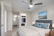 Huntington Beach apartment for rent - A bedroom with a large bed and a ceiling fan.