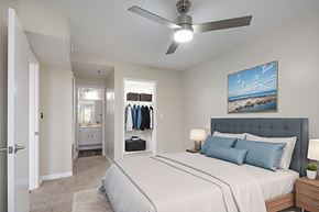 Huntington Beach apartment for rent - A bedroom with a large bed and a ceiling fan.