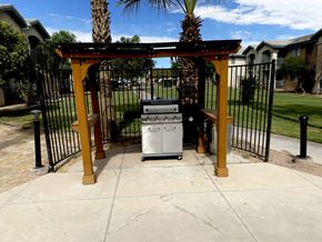 El Centro multi-family for rent - A white trash can sits under a wooden pergola.