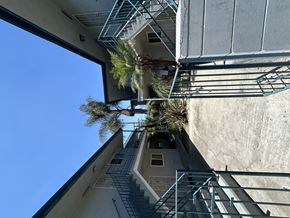 Carson multi-family for rent - A building with a metal staircase and a clear blue sky.