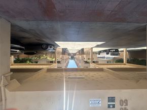 Gardena multi-family for rent - A parking garage with a concrete floor and a concrete ceiling.