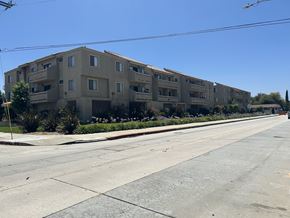 Gardena multi-family for rent - A long building with balconies is on the side of a street.
