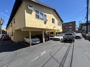 Los Angeles apartment for rent - A yellow building with a parking lot in front of it.