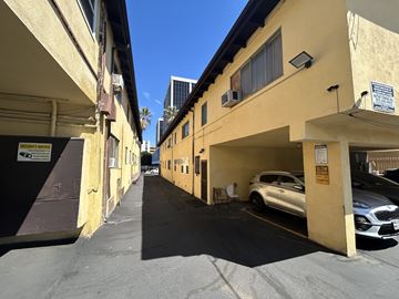 Los Angeles apartment for rent - A security notice sign is posted on a building.