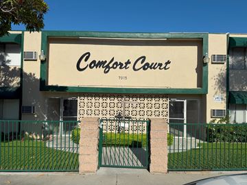 Whittier multi-family for rent - Comfort Court is a building with a green fence in front.