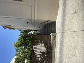 Los Angeles multi-family for rent - A white building with a tree in front of it.