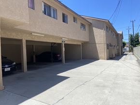 Gardena multi-family for rent - A parking garage with cars parked in it.