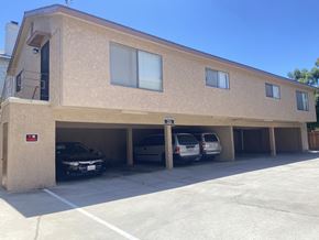 Gardena multi-family for rent - A building with a parking garage underneath it.