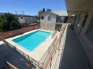 Gardena multi-family for rent - A small pool in a backyard with a metal fence around it.