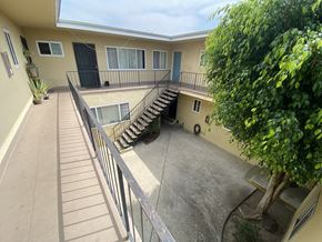 Harbor City multi-family for rent - A patio with a staircase and a tree.