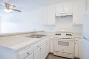 Paramount apartment for rent - A white kitchen with a fan on the ceiling.