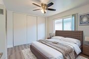 El Monte apartment for rent - A bedroom with a large bed and a ceiling fan.