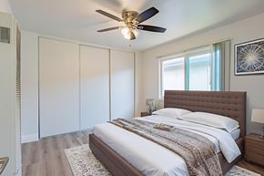 El Monte apartment for rent - A bedroom with a large bed and a ceiling fan.