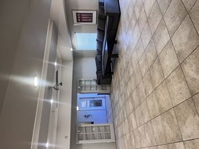 El Centro apartment for rent - A hallway with a tiled wall and a mirror on the wall.