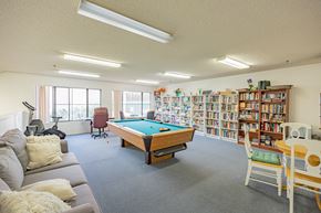 Santa Clarita multi-family for rent - A room with a pool table, couches, and bookshelves.