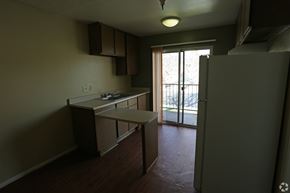 Ontario apartment for rent - A kitchen with a refrigerator, sink, and cabinets.
