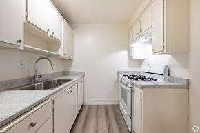 La Puente apartment for rent - A small kitchen with a sink, stove, and cabinets.