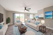 Montebello multi-family for rent - A living room with a couch, a coffee table, and a ceiling fan.