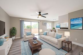 Montebello multi-family for rent - A living room with a couch, a coffee table, and a ceiling fan.
