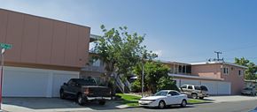Gardena multi-family for rent - A black truck is parked in front of a white garage door.