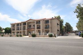 El Centro apartment for rent - A large apartment building with a parking lot in front.