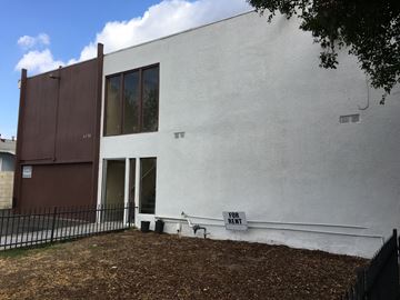 North Hollywood multi-family for rent - A white building with a brown door and windows.