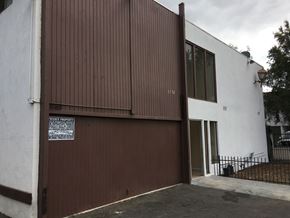 North Hollywood multi-family for rent - A white building with a brown garage door.