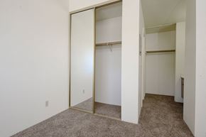 Hemet multi-family for rent - a bedroom with white walls and a carpeted floor at Park Columbia Apts, California