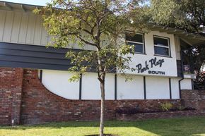 Temple City multi-family for rent - A tree in front of a building with a sign that says "Pit Plug South".