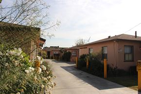El Monte multi-family for rent - A long driveway with a yellow sign on the side that says slow down.