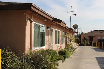 El Monte multi-family for rent - A long building with a satellite dish on top.
