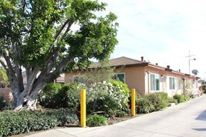El Monte multi-family for rent - A tree in front of a house with a sidewalk.