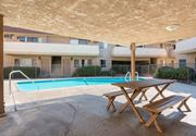 Montebello multi-family for rent - a pool with a picnic table in front of an apartment building at North View Terrace, California 