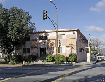 San Fernando multi-family for rent - A traffic light is green and a car is driving down the street.
