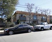 North Hollywood multi-family for rent - A black car is parked on the street in front of a house.