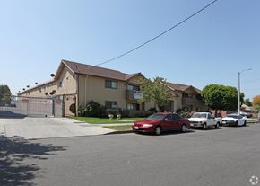 Sun Valley multi-family for rent - A red car is parked in front of a house with a fence.